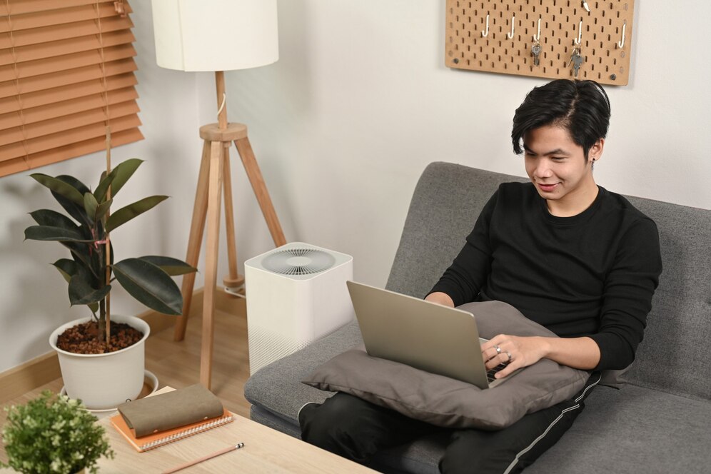 young-man-surfing-internet-with-laptop-sofa_35674-6434